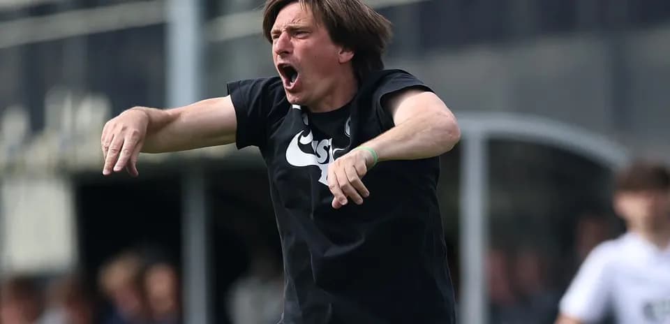 Coach passionately directing players from the sideline