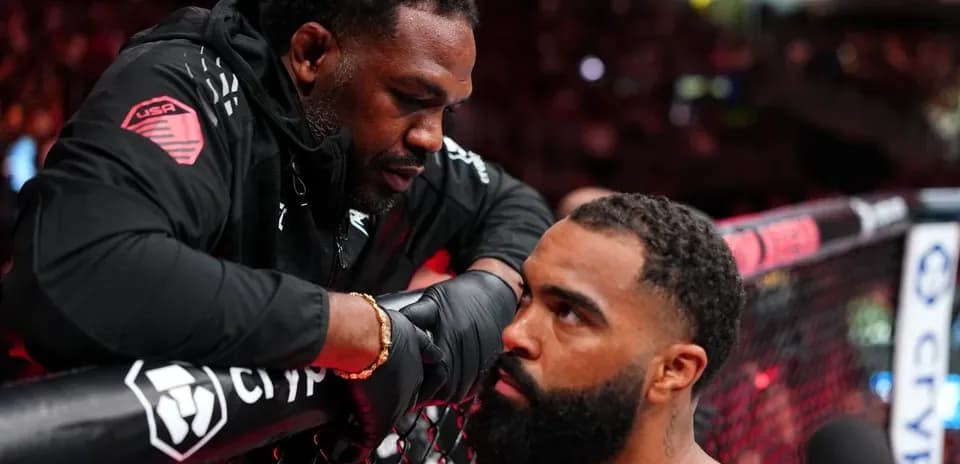 Trainer advising fighter in corner during match