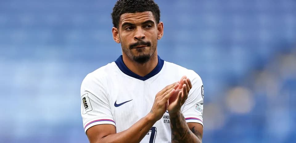 Player applauding in white national team jersey