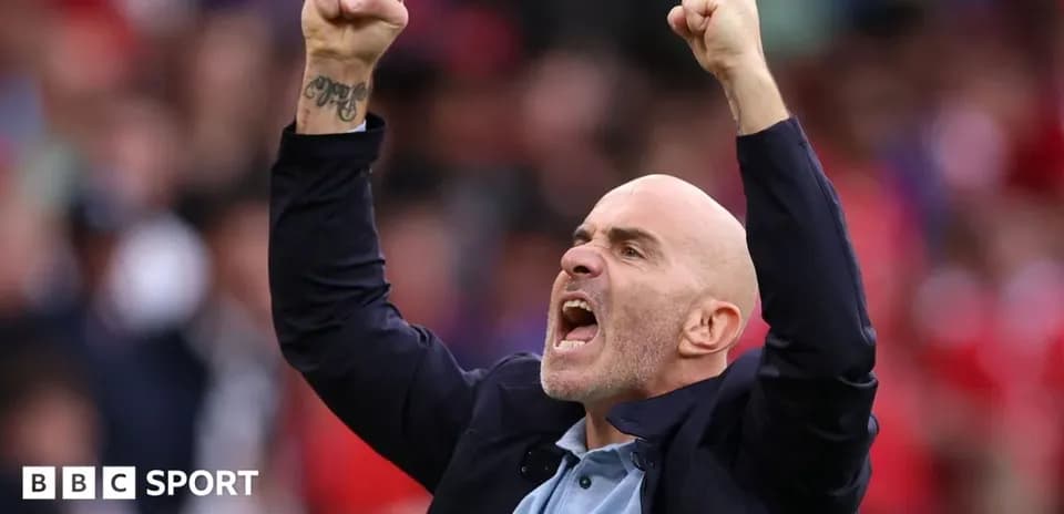 Coach celebrating during a match with raised fists