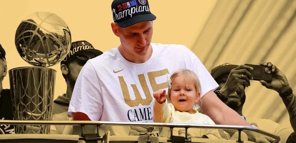 Player holding child during championship celebration parade