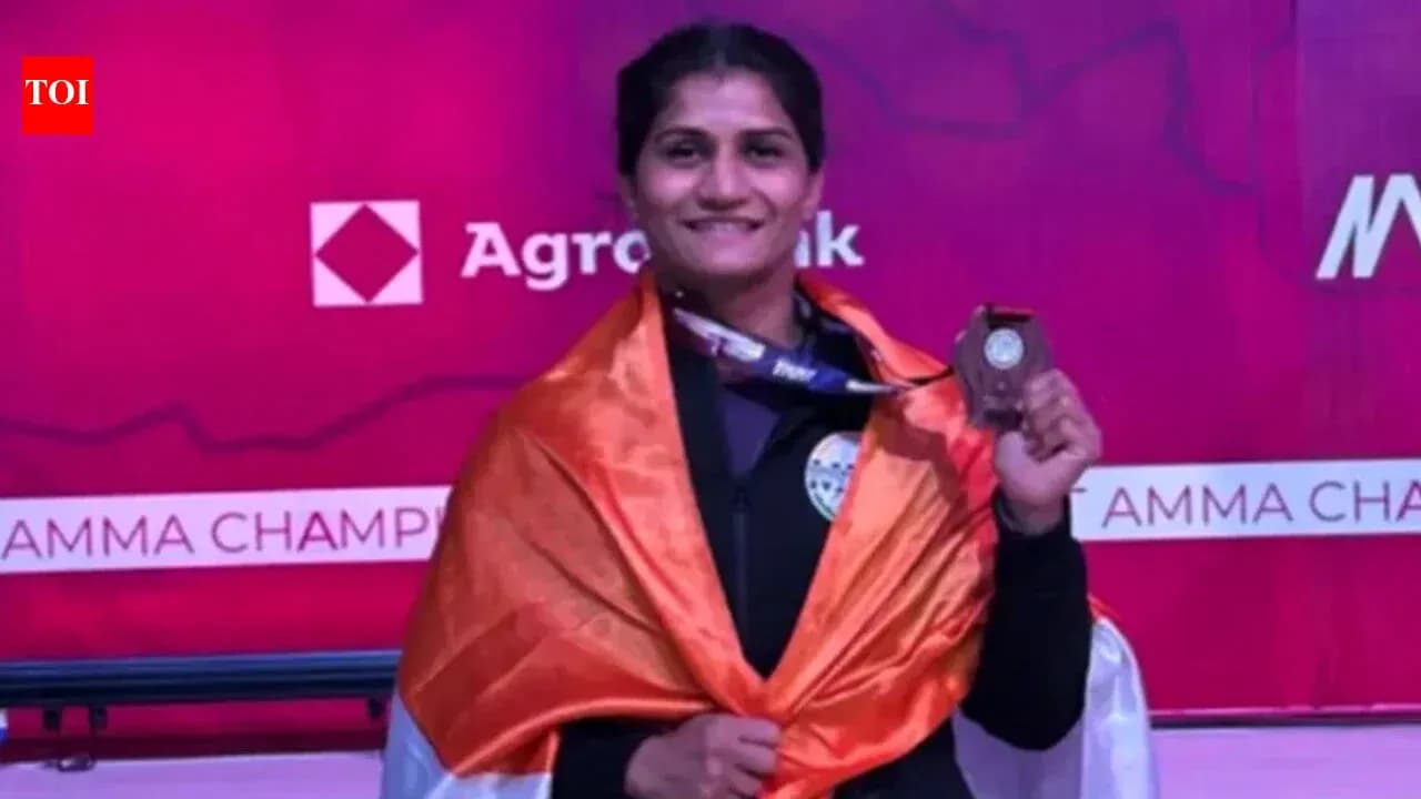 Athlete celebrating with medal and flag at championship