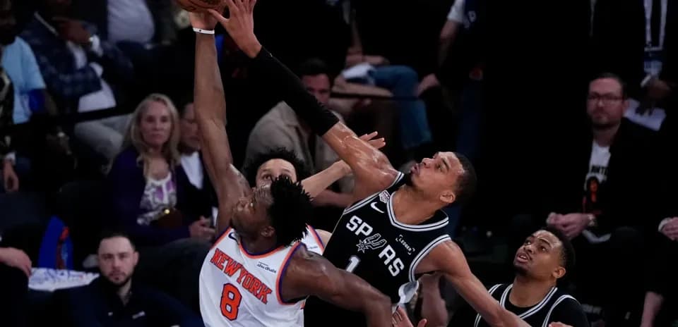 Player attempting a block during basketball game