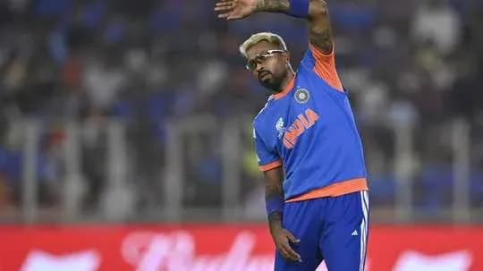 Cricketer waving during a match warm-up session