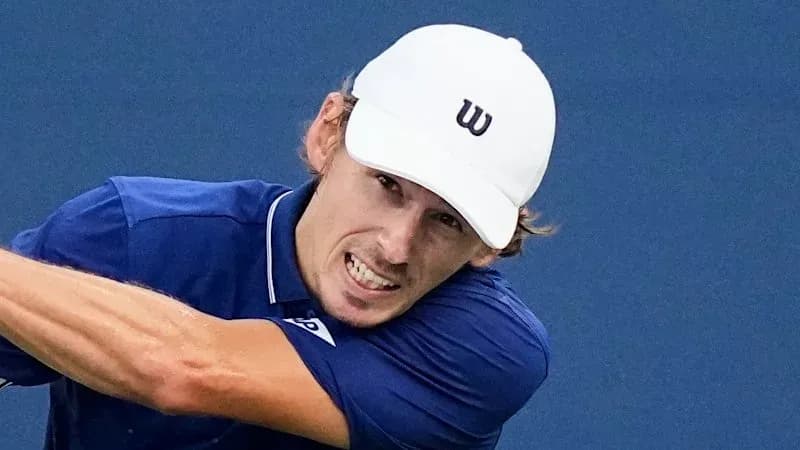 Tennis player hitting a forehand during match