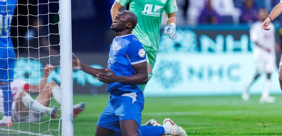 Player kneeling in front of goalpost after missed chance