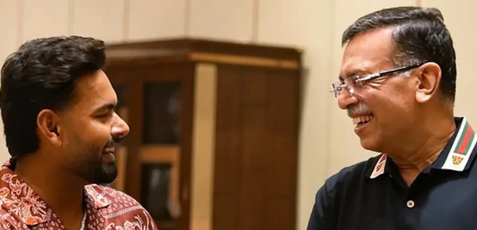 Two men smiling and engaging in conversation