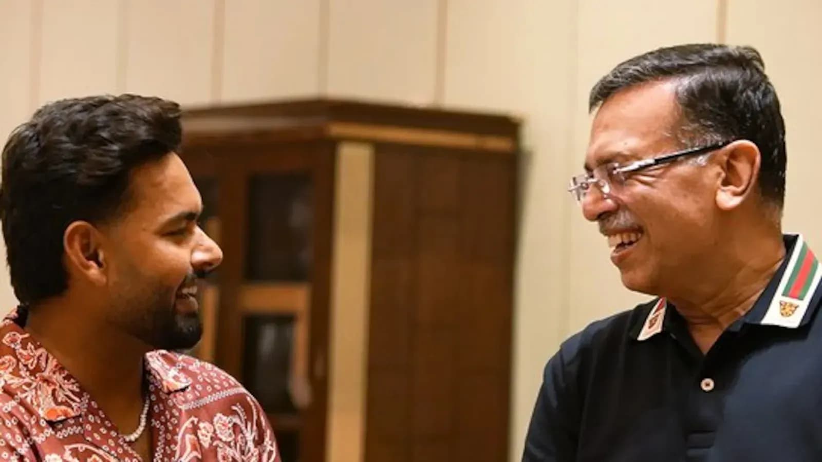 Two men smiling and engaging in conversation
