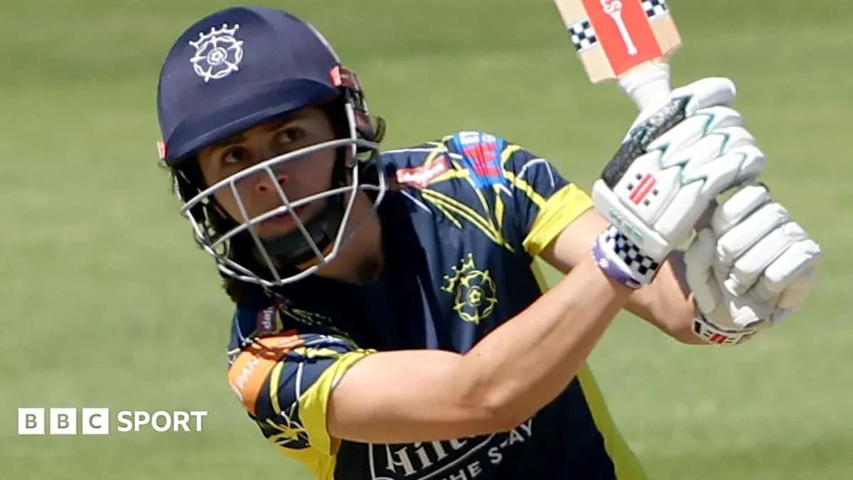 Cricketer batting during a match in uniform