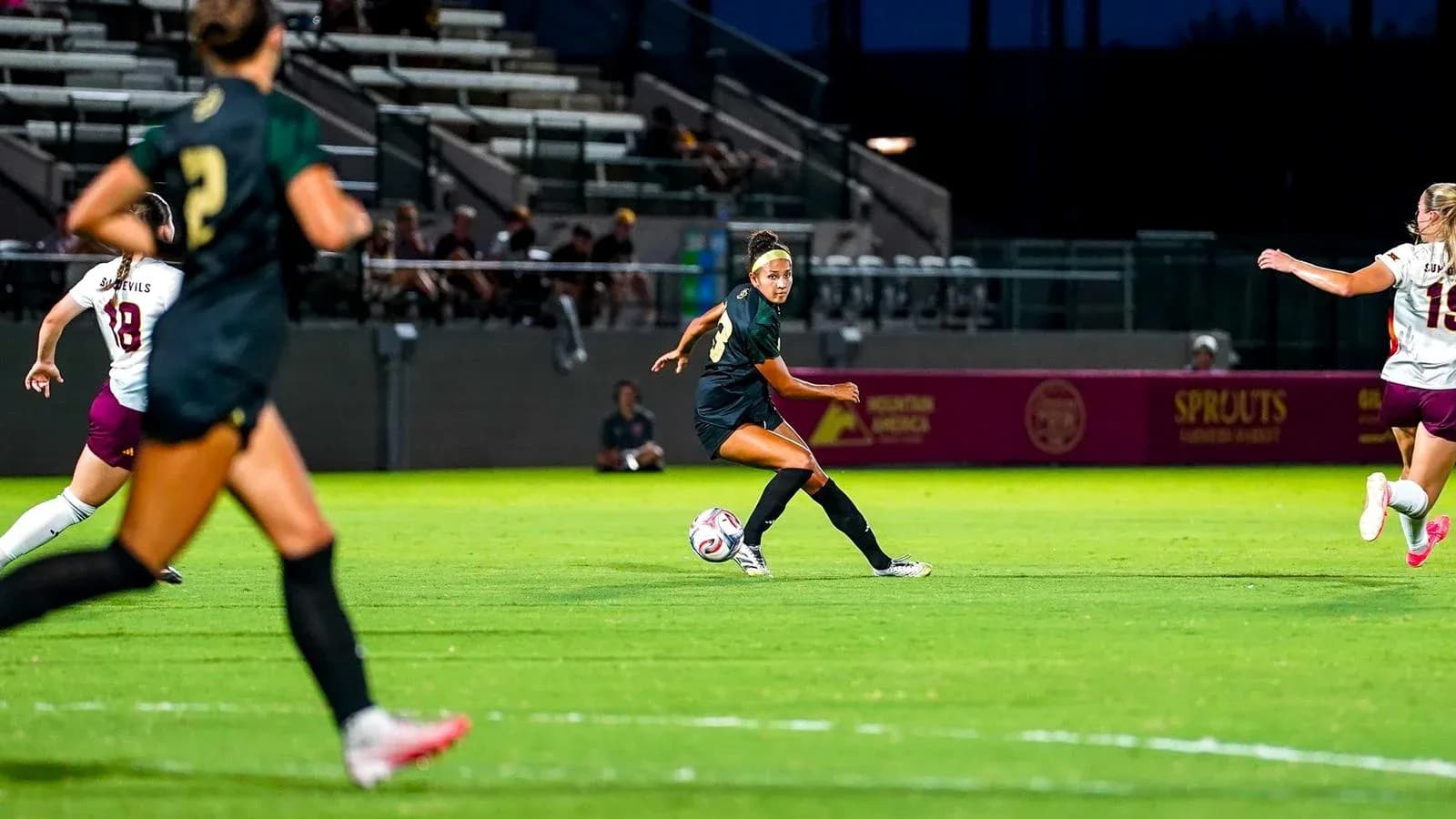 Player passing the ball during soccer match