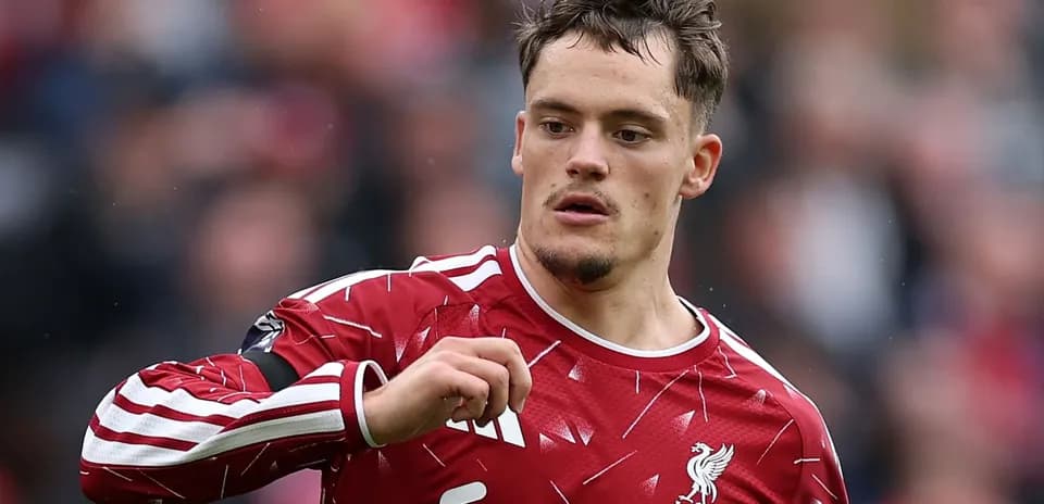 Player in Liverpool kit gesturing on the field