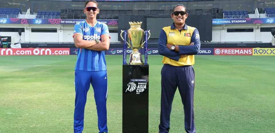 Two cricket team captains posing with trophy