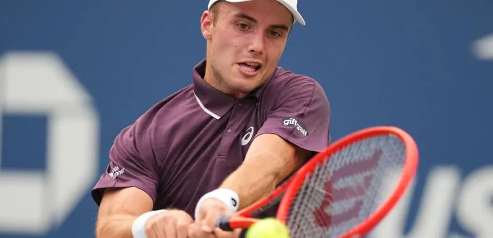 Tennis player hitting a forehand shot on court