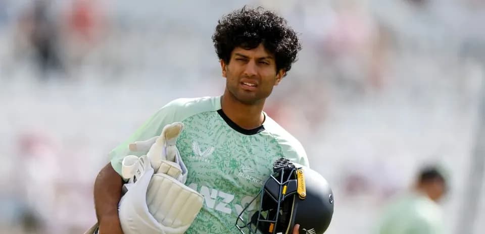 Cricketer carrying gear during practice session