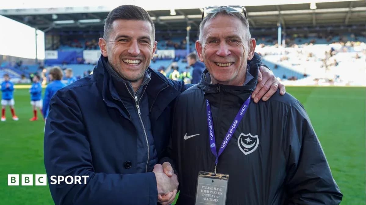 Two men shaking hands on a football pitch