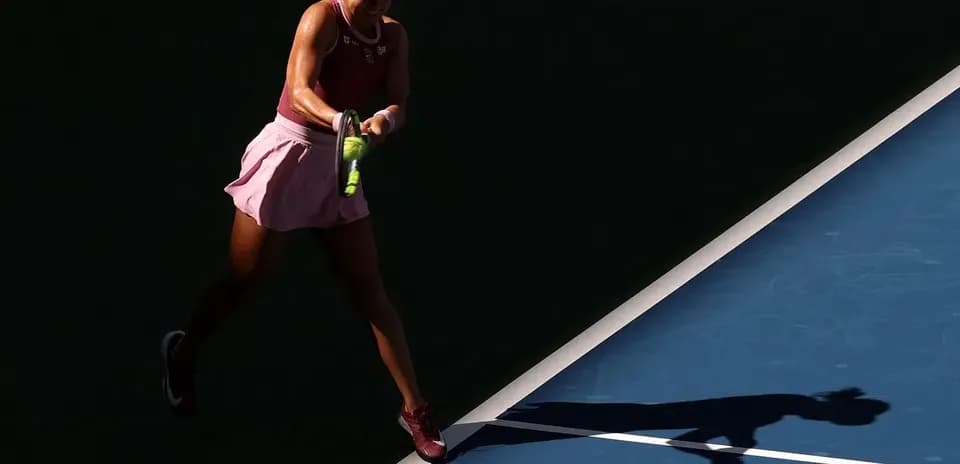 Player hitting a tennis ball on court