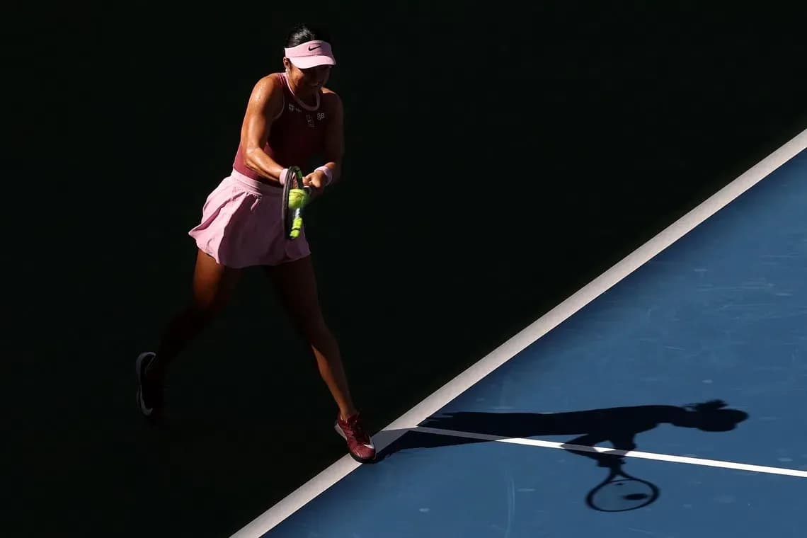 Player hitting a tennis ball on court