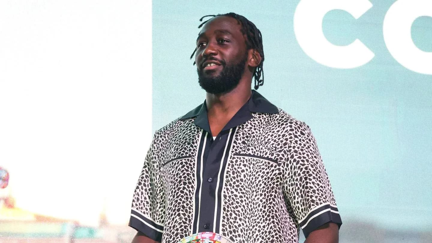 Athlete standing on stage holding a trophy