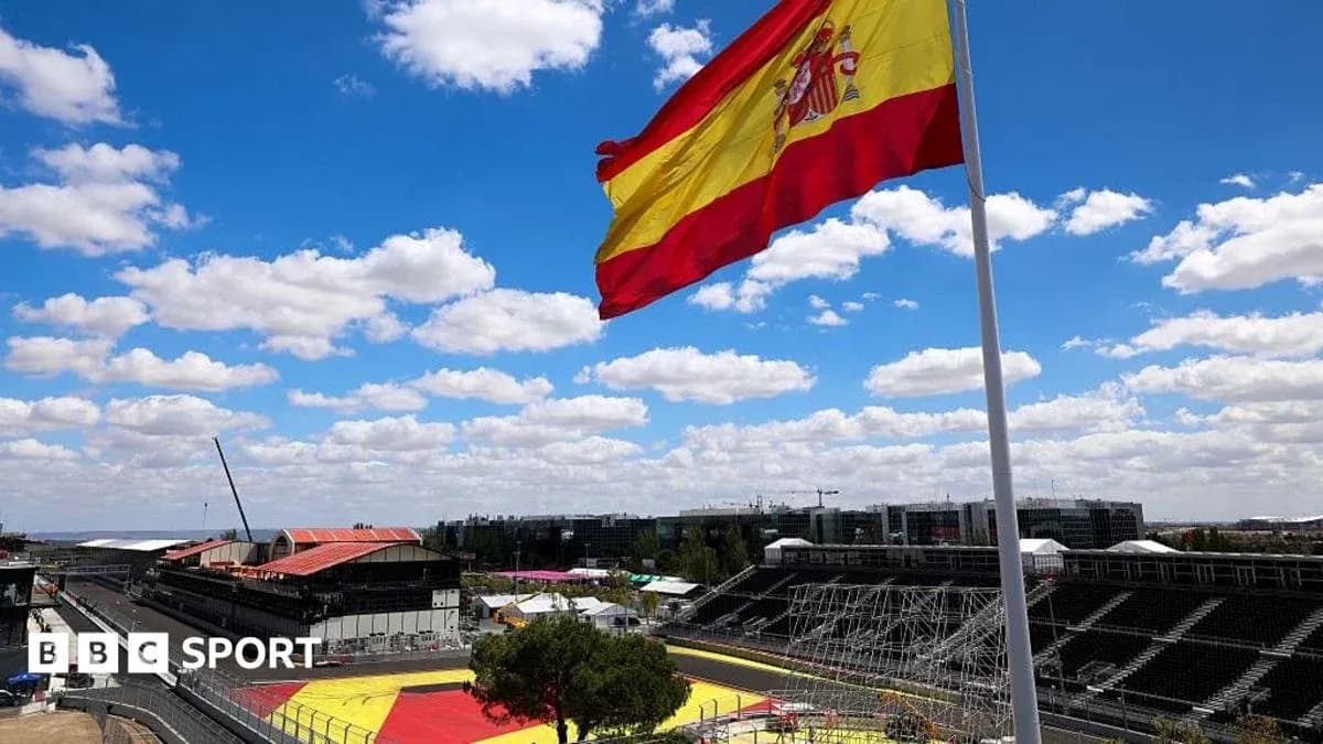 Spanish flag waving at racetrack under blue sky