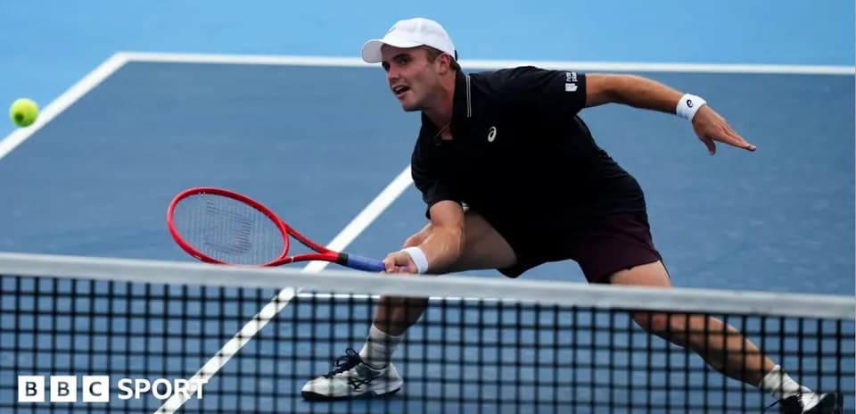 Player stretching to hit a tennis ball during match