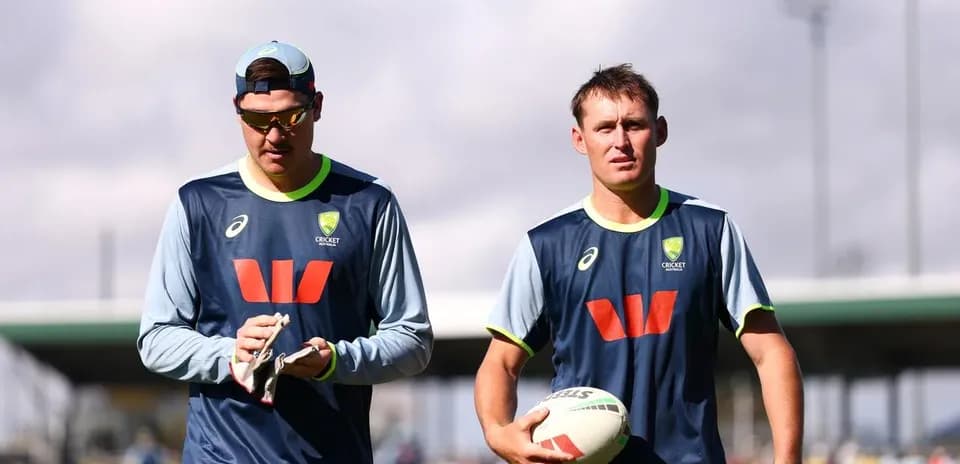 Two Australian cricketers walking during training session