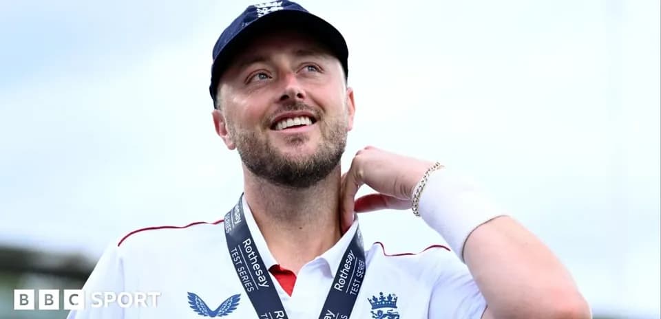 Cricketer wearing medal and smiling at ceremony