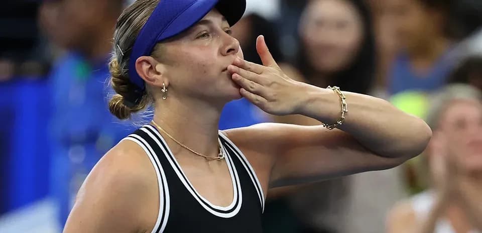 Tennis player blowing a kiss to the crowd