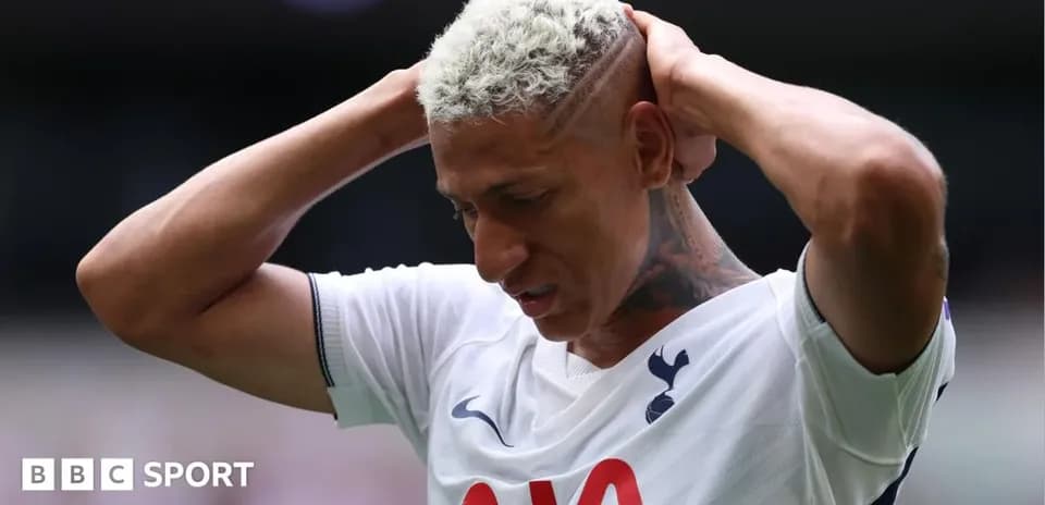Player holding head in frustration on the pitch