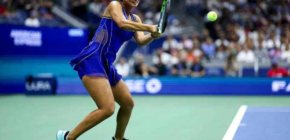 Player hitting a backhand during tennis match