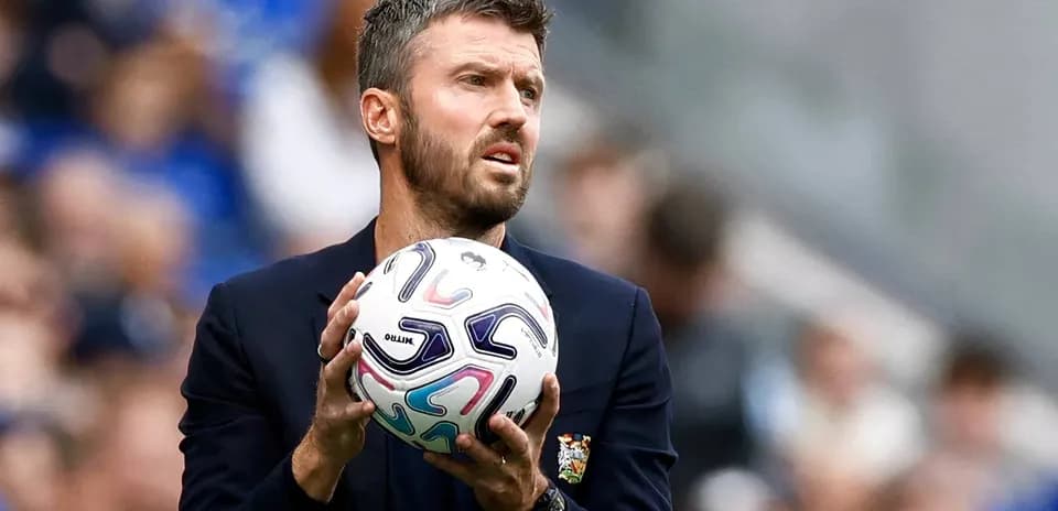 Coach holding a football during a match
