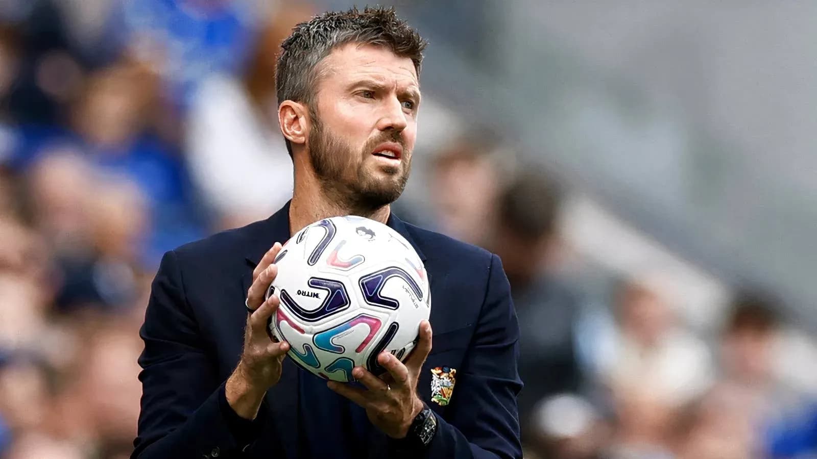 Coach holding a football during a match