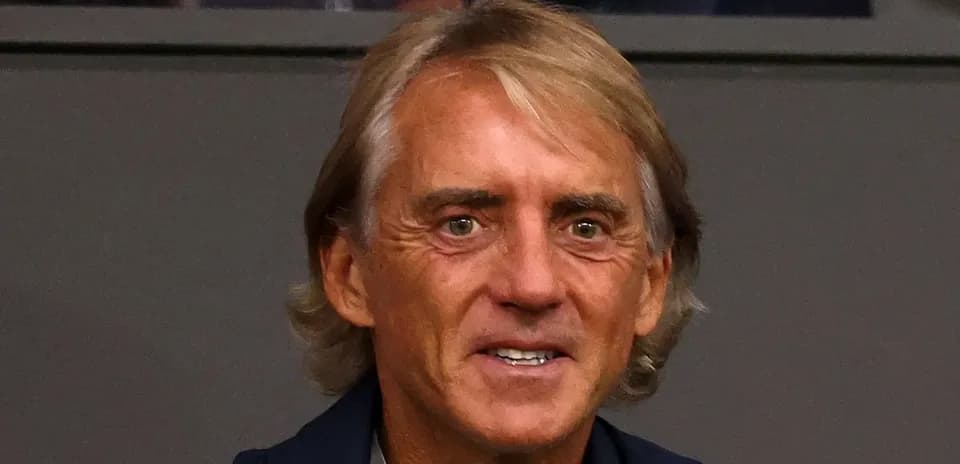 Coach smiling in a sports venue setting