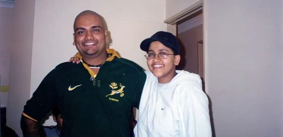 Two individuals smiling together indoors