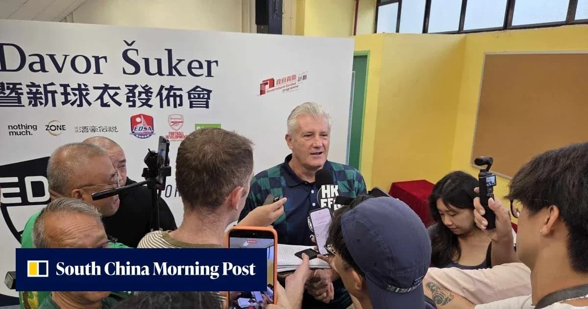 Davor Šuker speaking at a press event surrounded by reporters