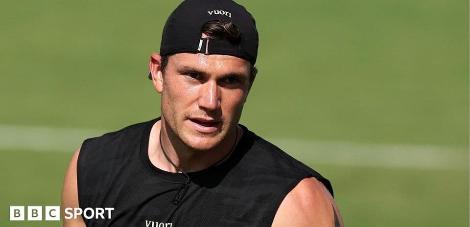 Athlete training on field in black tank top