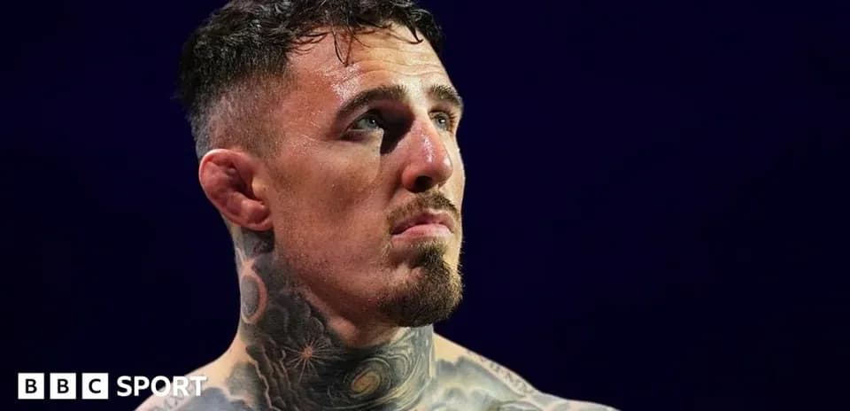 Tattooed fighter looking up in the ring
