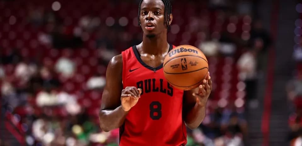 Player in Bulls jersey holding basketball during game