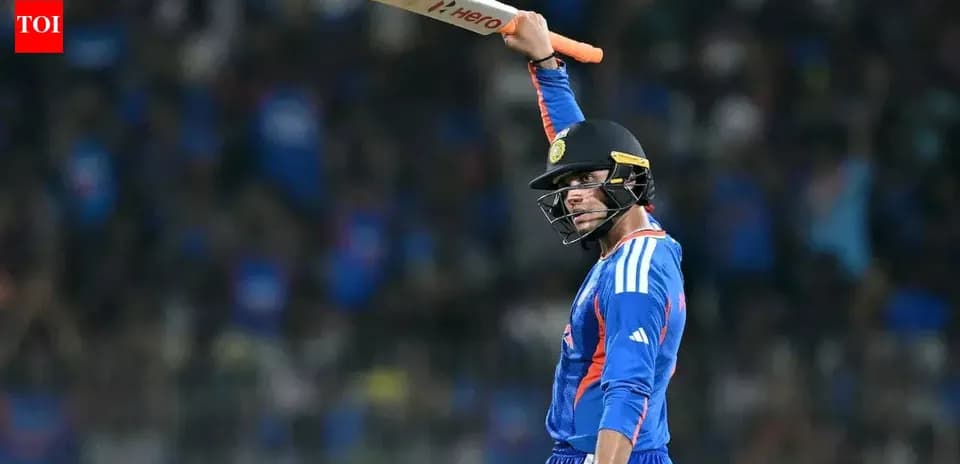 Cricketer celebrating with bat raised in stadium