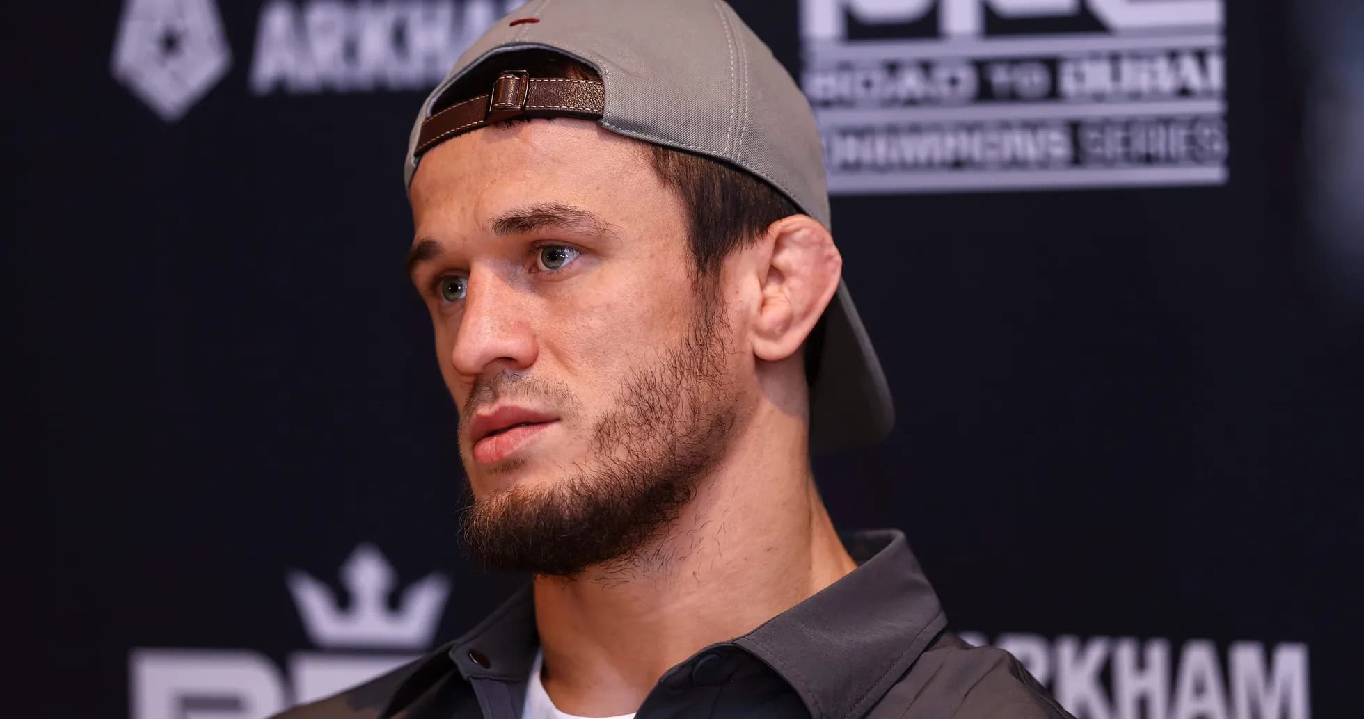Fighter at press conference wearing a cap