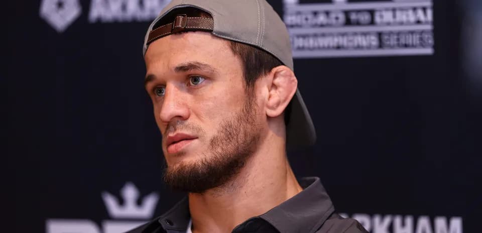 Fighter at press conference wearing a cap