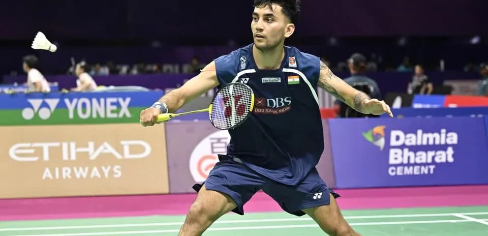 Badminton player preparing to hit shuttlecock on court