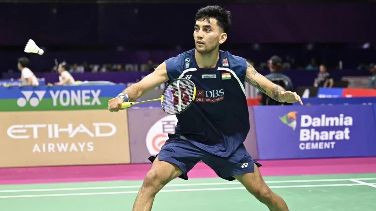 Badminton player preparing to hit shuttlecock on court