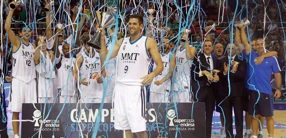 Basketball team celebrating victory with trophies
