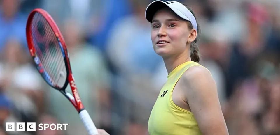 Tennis player holding racket and smiling on court