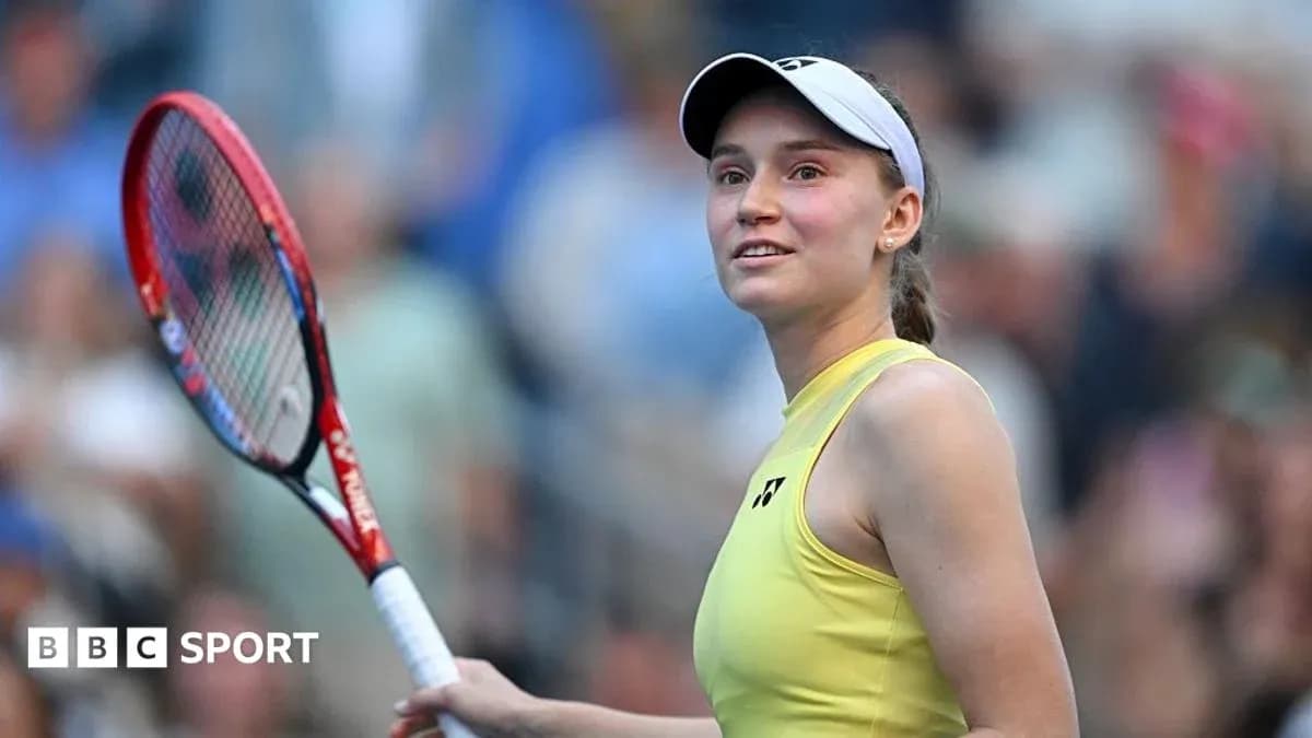 Tennis player holding racket and smiling on court