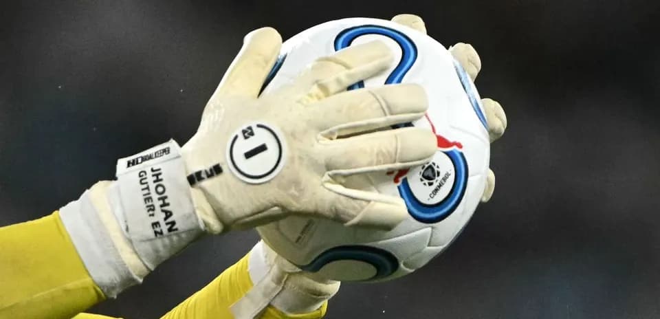 Goalkeeper catching a soccer ball in gloves
