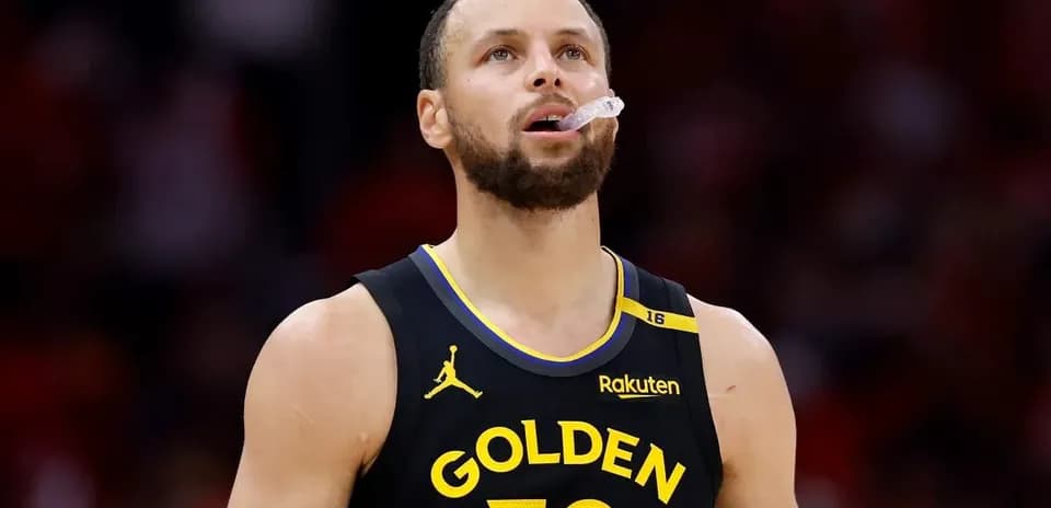 Player in Golden State Warriors jersey looking up