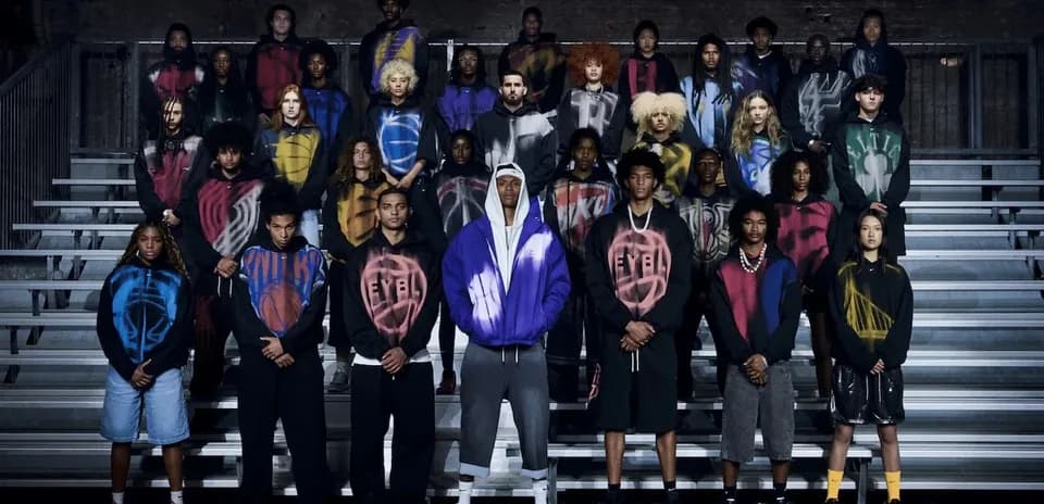 Group of individuals wearing colorful hoodies on bleachers