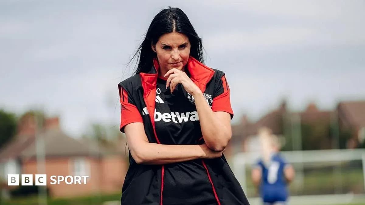 Female coach observing players during training session