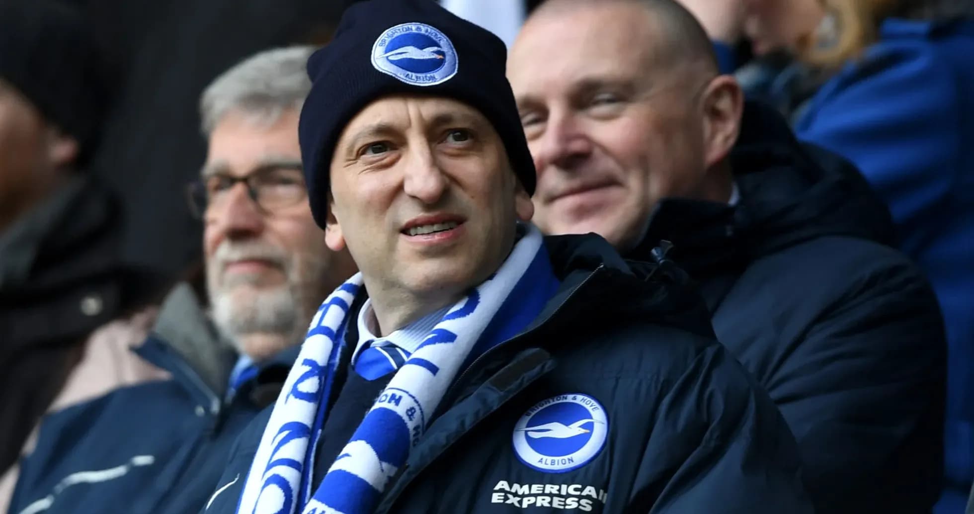 Man wearing a Brighton scarf and beanie at match